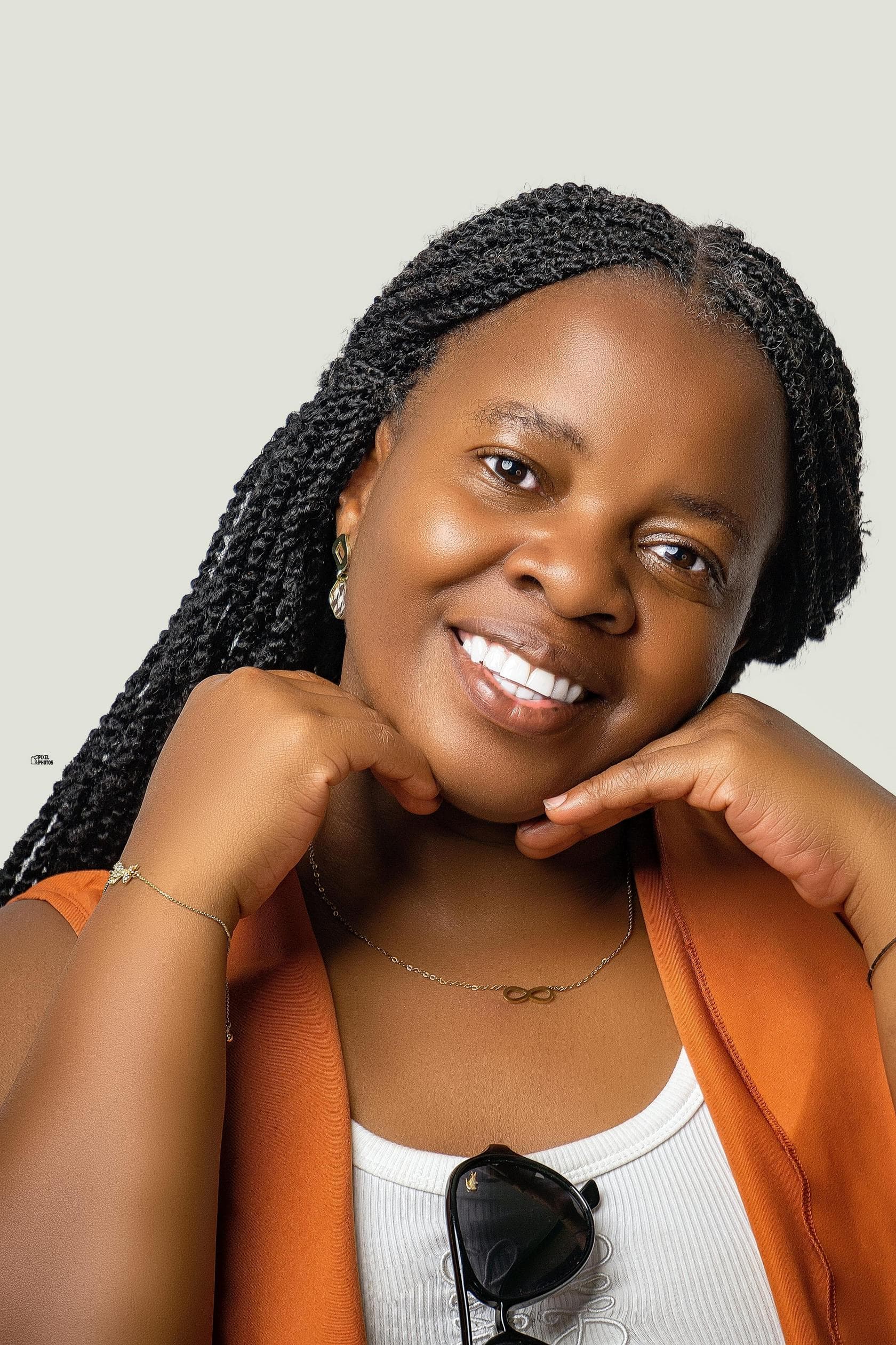 A person walking through a neon-lit city street at night